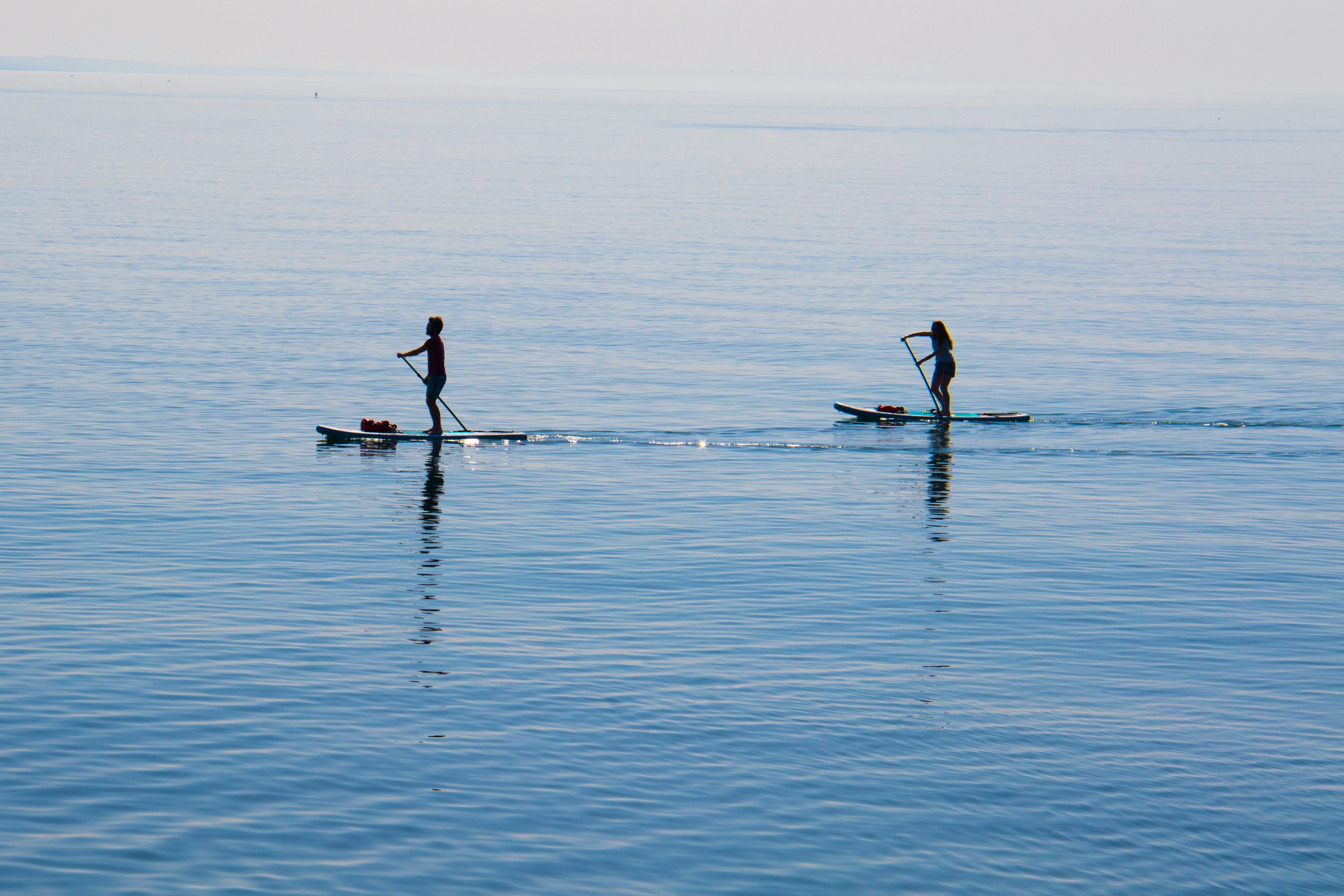 Two paddleboarders on calm water at Brighton